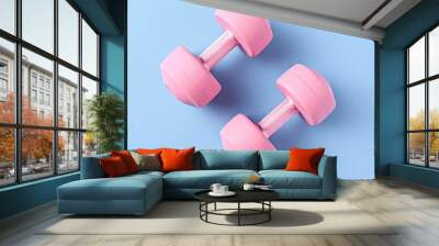 Home exercise equipment in blue dumbbells on a pink background pattern Flat lay gym for healthy lifestyle Top view Copy space image Place for adding text or design Wall mural