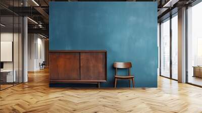 Scandinavian style old wooden cabinet and chair placed against a dark blue wall in a vintage setting. with copy space image. Place for adding text or design Wall mural