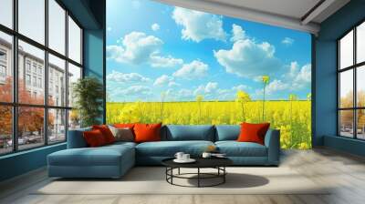 Scenic rural charm A beautiful summer landscape featuring a yellow rapeseed field under a blue sky with fluffy clouds perfect as a background image with copy space Wall mural