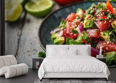 Seafood tuna fish ceviche salad featuring avocado lime hot chili pepper red onion cilantro and sesame seeds presented on a grey blue plate against a white wooden table background Close up Selective f Wall mural