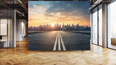 Sunset view of modern city skyline and mountain scenery from an empty asphalt road Wall mural