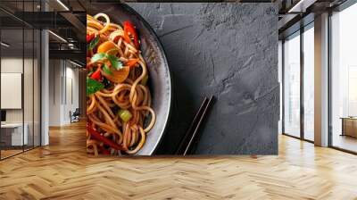 Top view of soba noodles with sweet and sour sauce and vegetables in a grey bowl Flat lay of Pan Asian cuisine Bowl with pho noodles and soba Copy space Menu banner or poster Vegan dish Wall mural