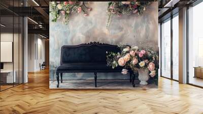 Vintage wedding party photo booth zone in studio, decorated with black sofa and white wood bench under the flowers. Copy space image. Place for adding text or design Wall mural