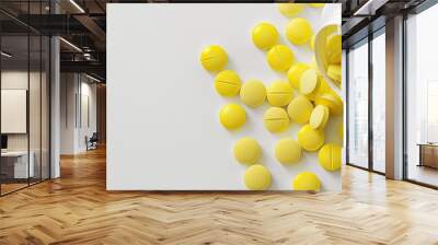 Yellow oval tablet pills and an opened white bottle are set against a white background with copyspace for text emphasizing the theme of medicine and health Wall mural