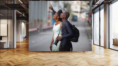 Tourist couple enjoying sightseeing and exploring city Wall mural