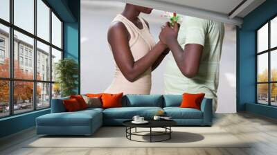 Young man offering a flowers to a beautiful woman Wall mural