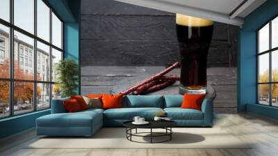 Dark beer with foam. Fresh dark beer and spicy sausages. Wall mural