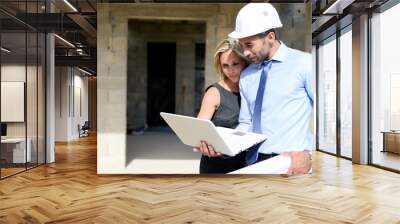 cute young woman architect with handsome foreman in building industry construction site Wall mural