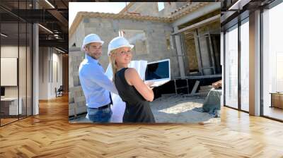 cute young woman architect with handsome foreman in building industry construction site Wall mural