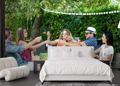 group of friends having fun picnic lunch party outdoor in backyard during summer holiday vacation Wall mural