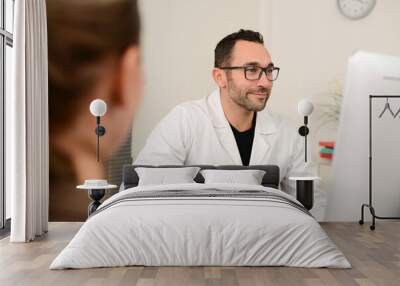 handsome male doctor with female patient in hospital consultation office desk Wall mural