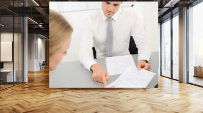 handsome young business man with customer in office signing agreement sales contract Wall mural