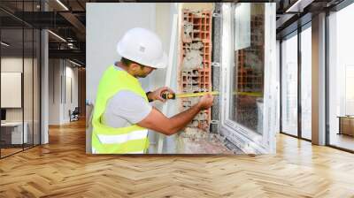 handsome young foreman supervising a house renovation contruction site Wall mural