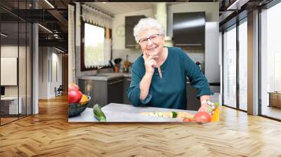 happy senior active woman cooking at home in a modern kitchen Wall mural