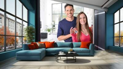 happy young couple at their new house front door proud to show home keys Wall mural