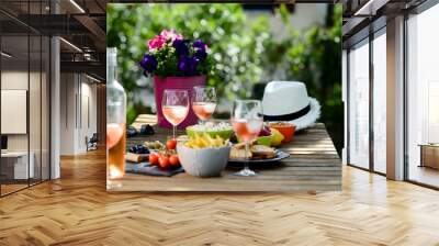 holiday summer brunch party table outdoor in a house backyard with appetizer, glass of rosé wine, fresh drink and organic vegetables Wall mural