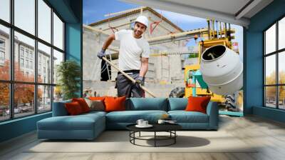 portrait of handsome construction worker on a building industry construction site Wall mural