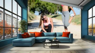 two beautiful healthy young womans running outdoor and doing fitness exercises in summer Wall mural