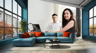 two business people man and woman working on computer while waiting in an airport lounge Wall mural