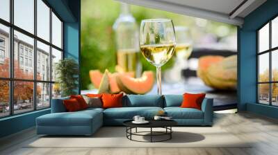 two glass of cool white wine with bottle outdoor in restaurant terrace during a sunny summer day Wall mural