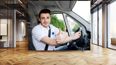 young man driving an ambulance paramedic transportation Wall mural