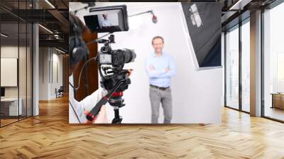 young man video camera operator making interview in professionnal broadcast tv movie studio film production Wall mural