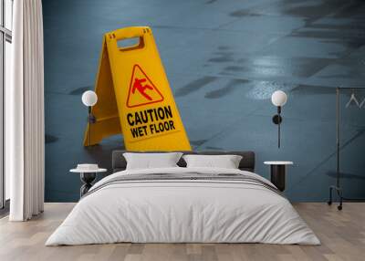 Yellow wet floor caution sign during rain with puddle of water when floor is slippery and copy space for text
 Wall mural