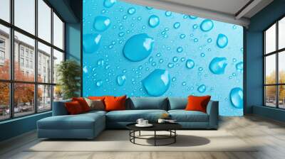 A close-up view of shiny water droplets on a vibrant blue surface, highlighting freshness and nature's beauty. Wall mural