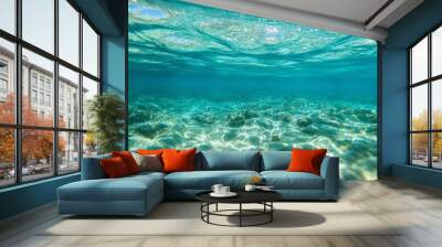 A stunning underwater scene showcasing crystal clear water, light reflections, and vibrant aquatic life beneath the surface. Wall mural