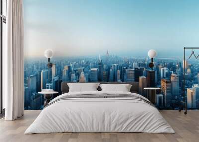 A panoramic view of a sprawling urban landscape, showcasing skyscrapers under a clear blue sky at dusk. Wall mural