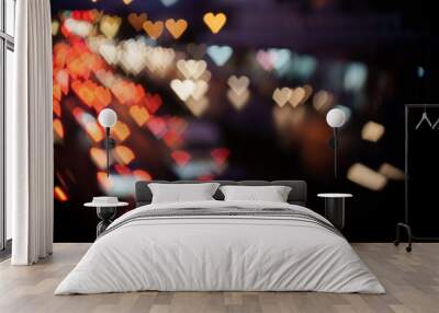 Heart-shaped Bokeh of lights from cars on the road at night. Wall mural