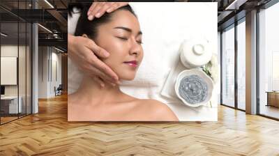 Woman lying and preparation face or head massage in spa Wall mural