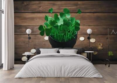 Top view photo of the black pots with many coins inside and around two stripped straws soft confetti in shape of clovers and silk tie bow on the wooden green background copyspace stock photoSt Wall mural