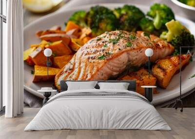 Grilled salmon fillet served with roasted sweet potato wedges and a side of steamed broccoli Wall mural