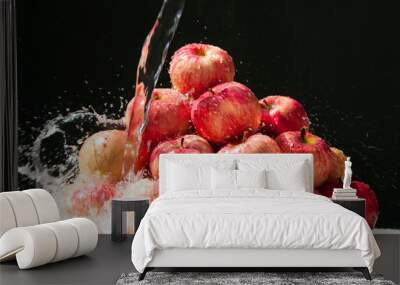 Melba apples. Ripe Melba apples with splashing water are stacked in a heap on a black background Wall mural