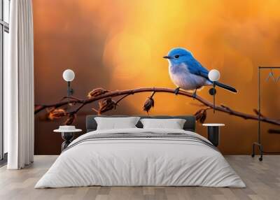  A blue-and-white bird perches on a thin twig against a softly blurred backdrop of leaves and branches Wall mural