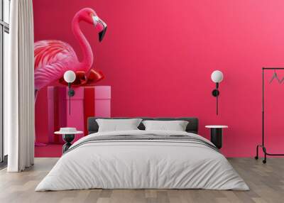  A pink flamingo atop a pink box, adorned with a red bow on its neck, and a red ribbon encircling its neck Wall mural