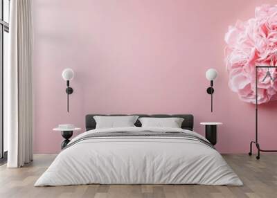  A pink flower against a pink backdrop, featuring a pink stem with a pink blossom at its tip Wall mural