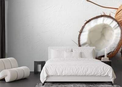  Two coconuts placed side by side on a white tabletop against a backdrop of a pristine white wall Wall mural