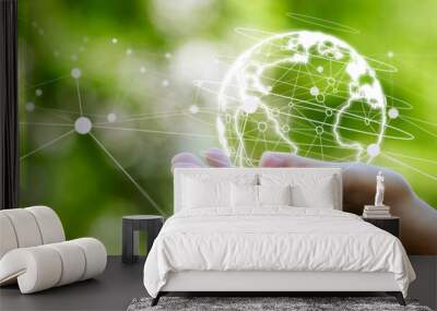 Earth in hand with network lines on green background. Green business concept. and green technology Wall mural