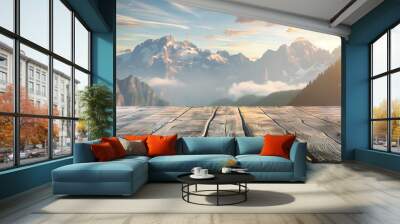 A wooden deck overlooking a mountain range with a clear blue sky. The view is serene and peaceful, with the sun shining brightly on the mountains. The wooden deck is a perfect spot to relax Wall mural