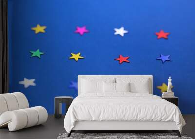 Flat lay of star decorations closeup on blue texture blur background Wall mural