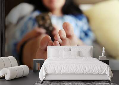 People feet closeup laying on bed relax in bedroom blur background Wall mural