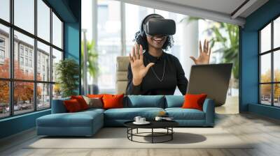 Businesswoman wearing virtual reality simulator gesturing at desk in office Wall mural