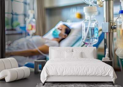 Close-up of IV bag and tubing connected to a patient's arm, with a variety of medication vials and medical equipment in the background. Wall mural