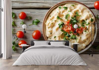 Creamy, cheesy, and delicious mac and cheese with fresh tomatoes and parsley on a rustic wooden table. Wall mural