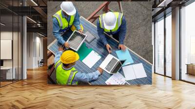 Top view of technician professional discussing the plan with solar photovoltaic panels at the workplace, sustainable development concept. Wall mural