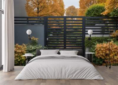 Modern Black Metal Gate in Garden with White Pillars, Green Shru Wall mural