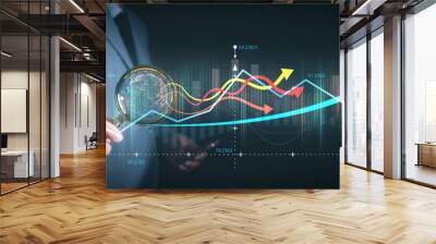 Businessman or trader using magnifying glass on a Virtual screen examine graph or chart. business analytical analysis trend stock performance economy finance commercial commerce technology, forex. Wall mural