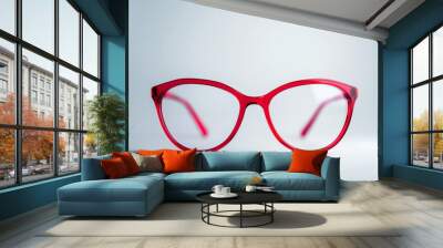 a pair of red glasses sitting on a table Wall mural